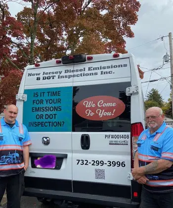 Two men standing in front of a white van.